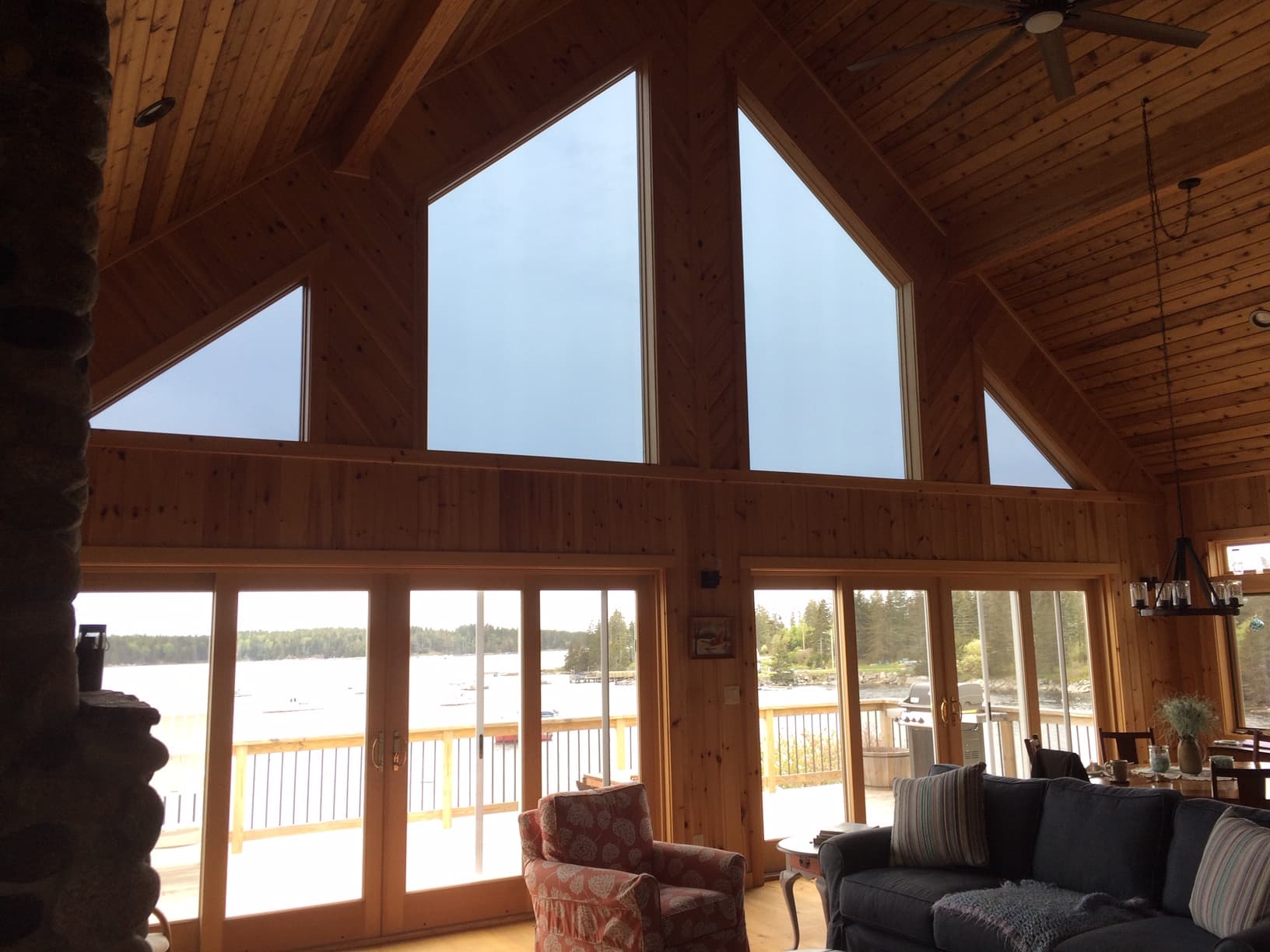Maine cabin great room with lake-view windows protected by residential window film